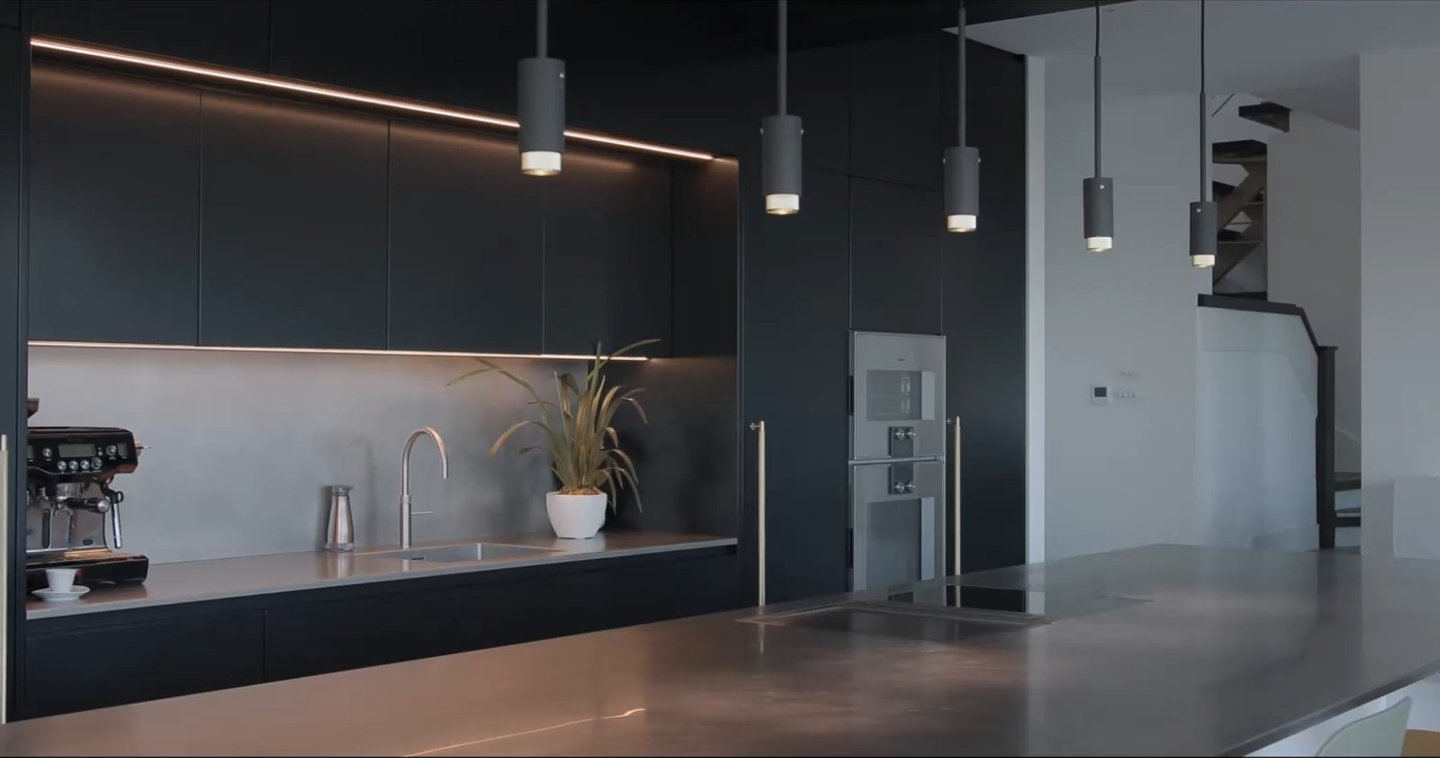 Dark bespoke kitchen with pendant lighting